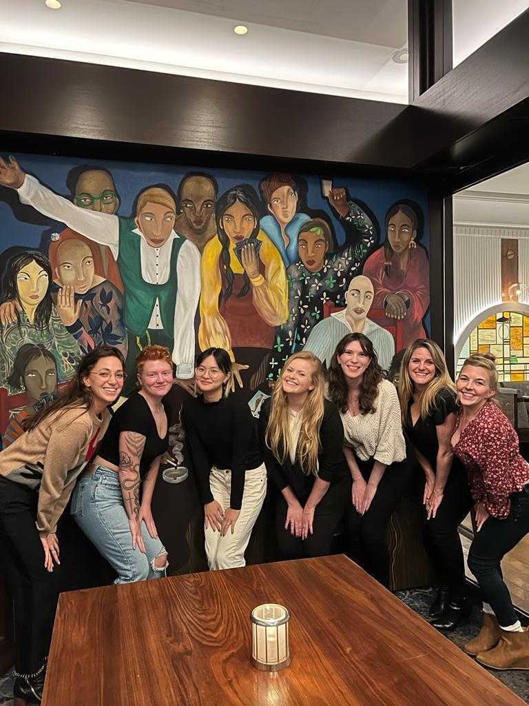 7 of Confetti's team members smiling together during a coworking meetup. 