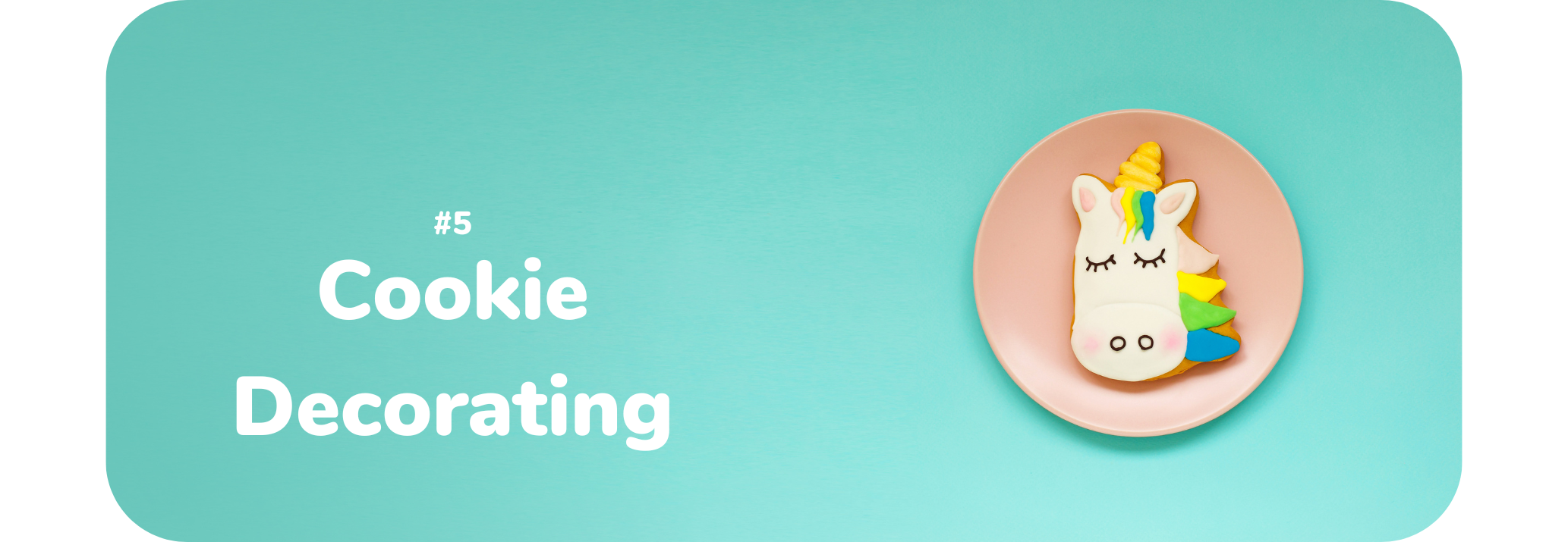 Light blue/green background with a pink plate on the right side. On top of the plate is a cookie with a unicorn shape and design. Text on the left reads "5 Cookie Decorating"